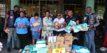 Members of the Hyena Motorcycle Club and other biker groups pose with His Majesty’s Correctional Services officials during a donation handover at the Mawelawela Women’s Correctional Centre