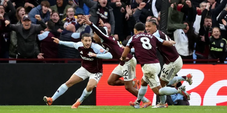 Aston Villa players celebrate Emiliano Buendía's dramatic last-minute winner against Arsenal at Villa Park.