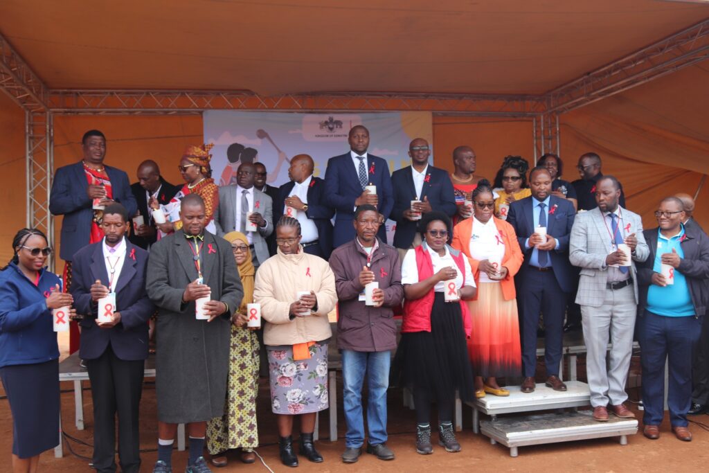 Prime Minister Russell Mmiso Dlamini joins senior government officials, including Health Minister Mduduzi Matsebula, in a candle lighting moment during the World AIDS Day 2025 ceremony at Hhukwini Inkhundla. Photo by Government.