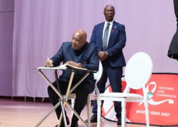 His Majesty King Letsie III signing at the World AIDS Day event. Photo: WHO Lesotho