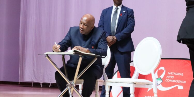His Majesty King Letsie III signing at the World AIDS Day event. Photo: WHO Lesotho