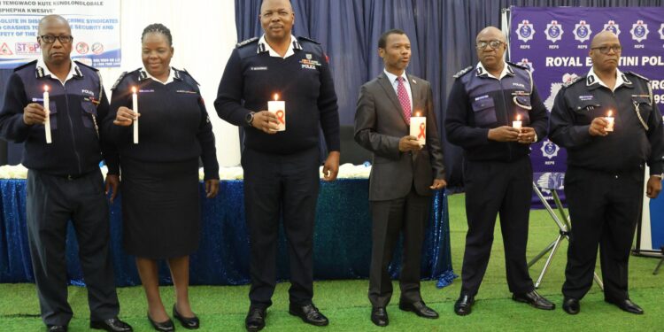Minister of Housing and Urban Development Appolo Maphalala with senior police officers doing AIDS observance. Photo, REPS