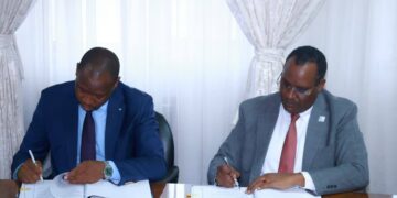 The Honourable Minister of Foreign Affairs, Lejone Mpotjoane, signs the host country agreement with an official from International IDEA in Maseru.