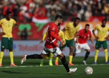 Egypt’s forward Mohamed Salah shoots from the penalty spot to score the team’s first goal [Franck Fife/AFP]