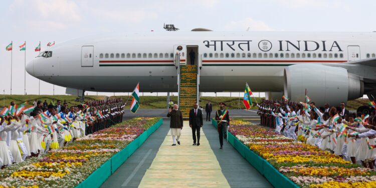 Indian Prime Minister Narendra Modi and Ethiopian Prime Minister Dr Abiy Ahmed Ali walk away from the plane, greeted by Ethiopian cultural dancers at Addis Ababa airport. Photo by X/@narendramodi