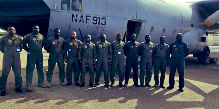 Pilots and crew of NAF C-130 (913) standing by their aircraft upon arrival at the Air Force Base in Accra, Ghana. Photo by Nigerian Air Force. Photo by X/@YusufTuggar