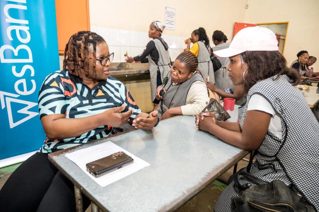 FNB Eswatini staff engage textile workers in Matsapha during a fraud awareness activation focused on safe banking and scam prevention. Photo by FNB Eswatini.