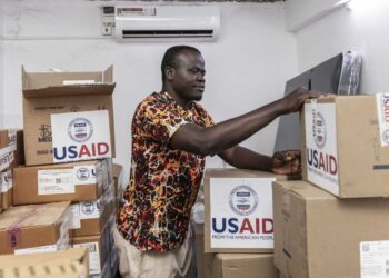 On April 24, Kenyan pharmacist Joseph Njer Airo inspects boxes of antiretroviral drugs labeled "USAID," from the last donation before the funding cuts. Michel Lunanga/via Getty Images