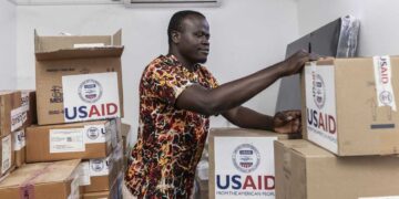 On April 24, Kenyan pharmacist Joseph Njer Airo inspects boxes of antiretroviral drugs labeled "USAID," from the last donation before the funding cuts. Michel Lunanga/via Getty Images