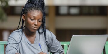 Student engaged in online learning with a laptop.