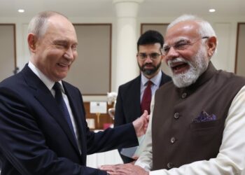 Putin and Modi share a lighter moment as they shake hands during the agreement ceremony. Photo by X/@narendramodi