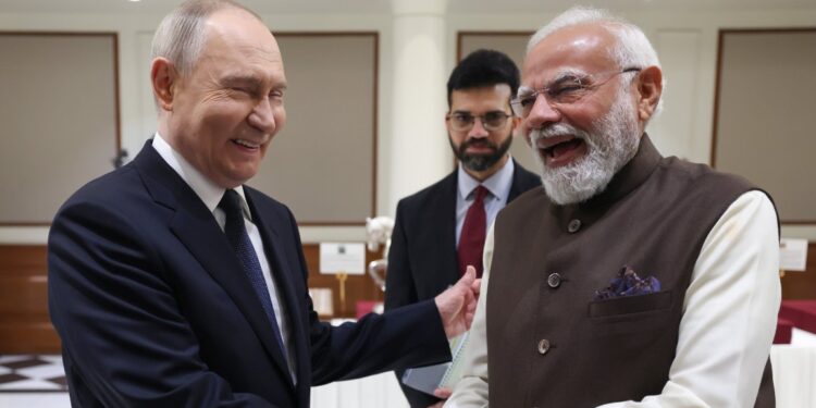Putin and Modi share a lighter moment as they shake hands during the agreement ceremony. Photo by X/@narendramodi