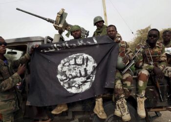 Nigerian soldiers pose with a Boko Haram flag recovered during military operations in northeastern Nigeria. Image: Reuters Emmanuel Braun