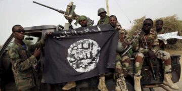 Nigerian soldiers pose with a Boko Haram flag recovered during military operations in northeastern Nigeria. Image: Reuters Emmanuel Braun
