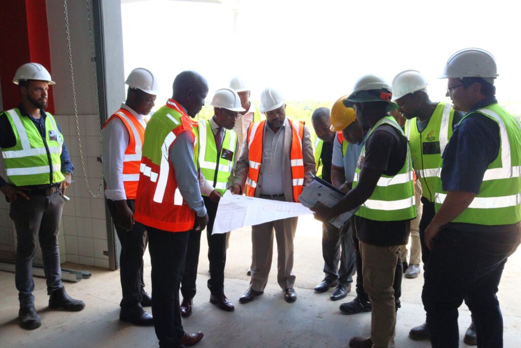 Minister for Health Mduduzi Matsebula reviews the waste management plant plans with engineers during a site visit in Matsapha. Photo by Ministry of Health