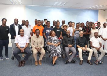 Graduated tertiary students pose for a group photo with representatives from the Ministry of Information Communications and Technology