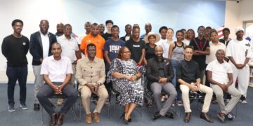 Graduated tertiary students pose for a group photo with representatives from the Ministry of Information Communications and Technology