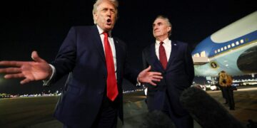 U.S. President Donald Trump speaks to members of the media, alongside Secretary of the Interior Doug Burgum, ahead of boarding Air Force One to depart for Washington, at Palm Beach International Airport in West Palm Beach, Florida, U.S., January 19, 2026. REUTERS/Kevin Lamarque