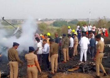 Emergency personnel and people gather next to smouldering wreckage at the site of a plane crash, in which Maharashtra's Deputy Chief Minister Ajit Pawar and four others were killed, in Baramati, Maharashtra, India. ANI/Handout via REUTERS