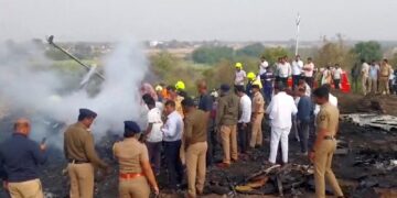 Emergency personnel and people gather next to smouldering wreckage at the site of a plane crash, in which Maharashtra's Deputy Chief Minister Ajit Pawar and four others were killed, in Baramati, Maharashtra, India. ANI/Handout via REUTERS