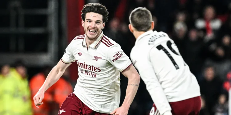 Declan Rice and Leandro Trossard celebrate after Rice's stunning second-half brace sealed Arsenal's 3-2 win over Bournemouth.