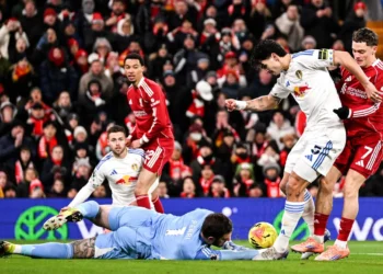 Leeds United players scramble and tackle inside Liverpool’s 18-yard box to preserve a goalless draw at Anfield.