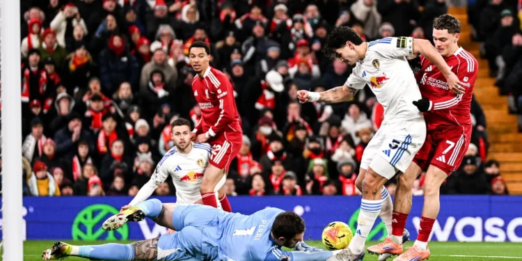 Leeds United players scramble and tackle inside Liverpool’s 18-yard box to preserve a goalless draw at Anfield.