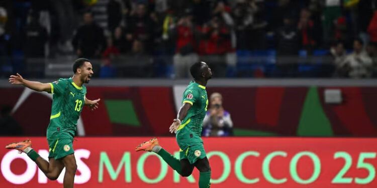 Sadio Mané celebrates his winning goal for Senegal at Ibn Batouta Stadium.