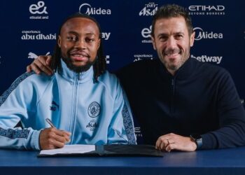 Ghana international Antoine Semenyo poses with a Manchester City representative after signing his contract at the Etihad Stadium. Photo Manchester City