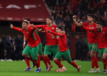 Morocco players celebrate after Youssef En Nesyri converts the decisive penalty to send the hosts into the AFCON 2025 final in Rabat.