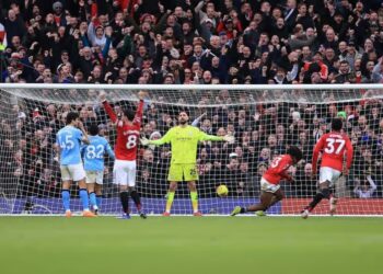 Patrick Dorgu gets in front of Rico Lewis to score Manchester United’s second goal during the Premier League Manchester derby against Manchester City at Old Trafford.