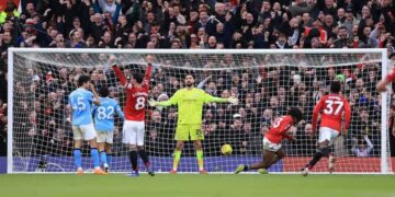 Patrick Dorgu gets in front of Rico Lewis to score Manchester United’s second goal during the Premier League Manchester derby against Manchester City at Old Trafford.