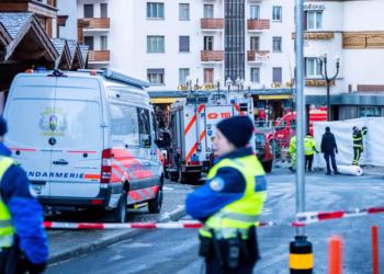 Police officers stand guard at the site of an explosion that ripped through the bar Le Constellation in Crans-Montana on Thusday. Maxime Schmid/AFP/Getty Images