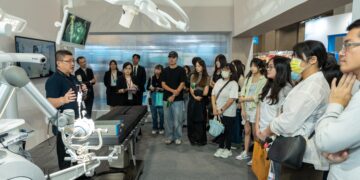 Exhibitor interacts with visitors at Medical Taiwan 2025, showcasing the latest innovations in healthcare.