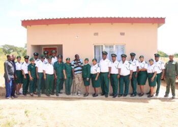 Mr Henry Nkambule poses for a group photo outside his new home with HMCS officials, community leaders, and neighbours. Photo courtesy of His Majesty’s Correctional Services.