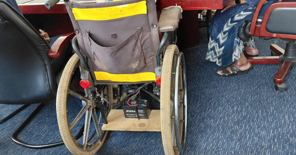 A close up view of the battery and electrical components installed on Sifiso Maseko’s wheelchair, powering the lights and horn in the first phase of the modification.