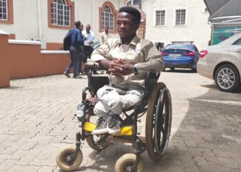 Sifiso Maseko, an Auto Electrical student at BSA Training Centre, showcases his modified wheelchair fitted with lights, a horn and reflectors as part of his innovation project. Photo by DPMO