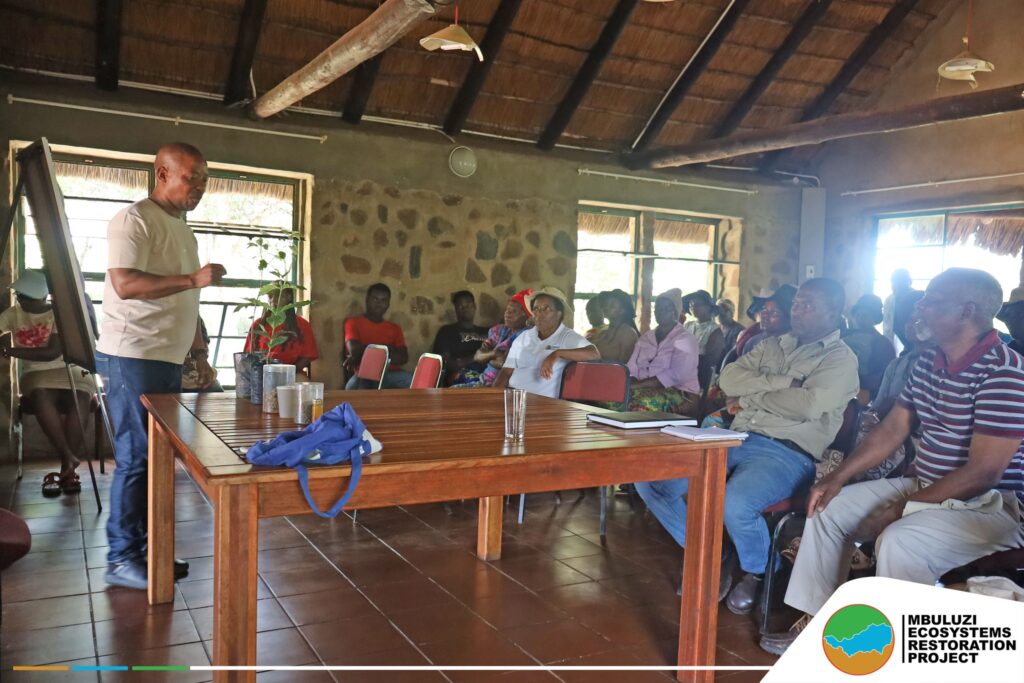 Facilitator guides Shewula community members on planting and caring for indigenous and fruit trees. Photo by Mbuluzi Ecosystems Restoration Project.