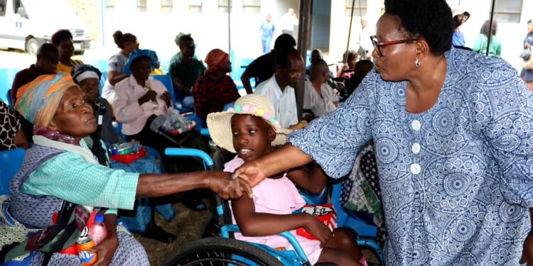 Senator Thulisile Dladla interacts with residents during the Thanksgiving Celebration Ceremony at the Mankayane Old Age Home and Facility for Persons with Disabilities.