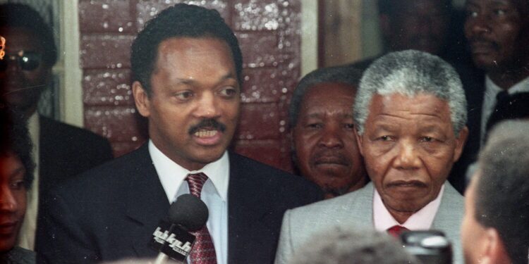 American civil rights leader Jesse Jackson and freed South African black nationalist leader Nelson Mandela answer reporters' questions after Jackson's visit to Mandela's Soweto house February 15, 1990. REUTERS/File Photo