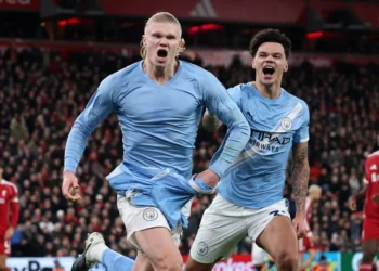 Erling Haaland celebrates after converting a late penalty at Anfield, capping Manchester City’s dramatic comeback against Liverpool.