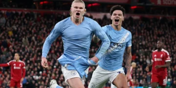 Erling Haaland celebrates after converting a late penalty at Anfield, capping Manchester City’s dramatic comeback against Liverpool.