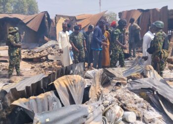 People look on as Nigerian Military arrives at Woro community, after an overnight attack by gunmen that killed dozens of residents, in Kaiama Local Government Area of Kwara State, Nigeria, February 4, 2026. Picture taken with a mobile phone. REUTERS/Oluseyi Dasilva