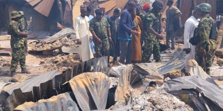 People look on as Nigerian Military arrives at Woro community, after an overnight attack by gunmen that killed dozens of residents, in Kaiama Local Government Area of Kwara State, Nigeria, February 4, 2026. Picture taken with a mobile phone. REUTERS/Oluseyi Dasilva