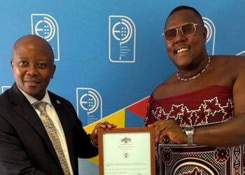Melusi Zox Dlamini, chairman of A Peculiar People, with Eswatini Intellectual Property Office registrar Dr Celucolo Dludlu during the official handover following the registration of the Made in Eswatini trademark in Mbabane. Photo by A Peculiar People.