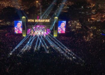 Festival goers fill the grounds of House On Fire during MTN Bushfire 2025 as South African music icon Thandiswa Mazwai delivers a powerful performance on the main stage.