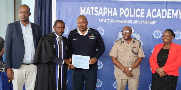 National Commissioner of Police, Mr Manoma Vusie Masango, presents a Diploma in Police Science certificate to one of the 27 graduating officers at the Matsapha Police Academy on February 17, 2026.