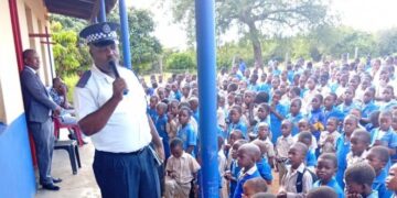 A police officer speaks to school learners at Njonjane Primary School on bullying and safety awareness. Photo by REPS