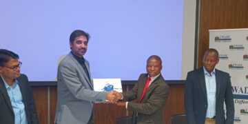 EWADE CEO Dr Samson Sithole shakes hands with a representative of GVPR Engineers Limited after signing the MNWAP Phase 1B Main Conveyance Pipeline contract on Monday.