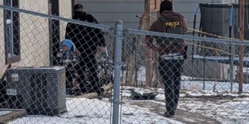 ICE agents stand next to a boy, who a witness identified as Liam Conejo Ramos, a five-year-old that school officials said was detained in Minneapolis, Minnesota, U.S., January 20, 2026. Rachel James/via REUTERS